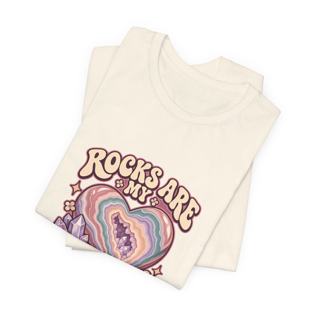 Royelle Rocks Are My Love Language T-shirt in Natural, folded front view, with pastel agate heart, crystals and flowers and slogan.
