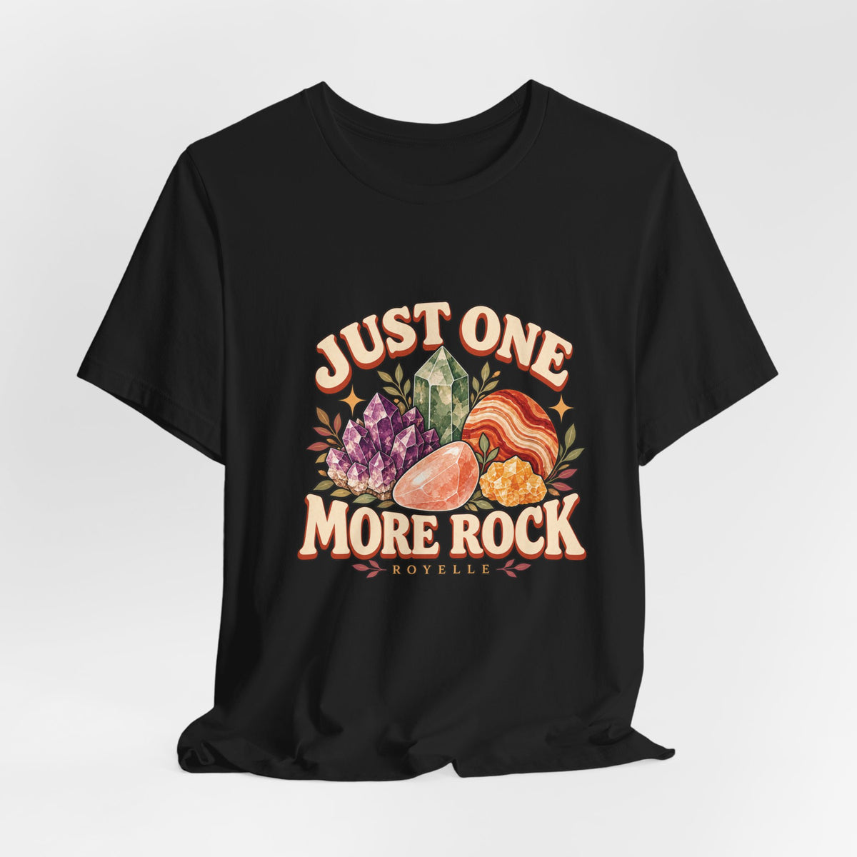 Royelle Just One More Rock T-shirt in Black, hanging front view, with colorful illustrated minerals and slogan.