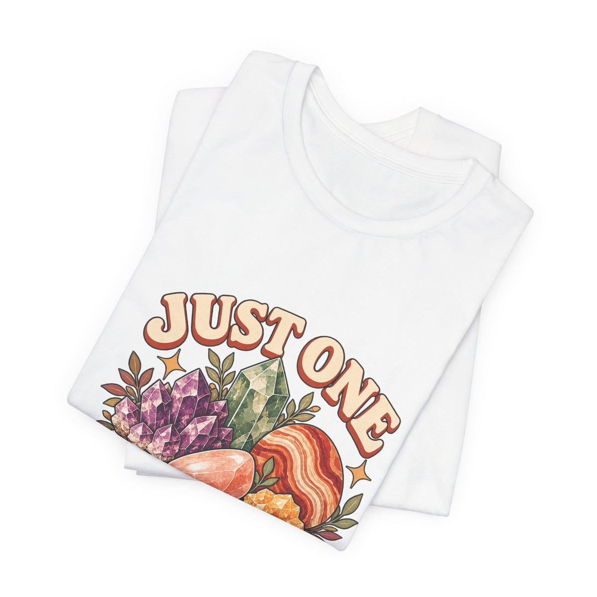 Royelle Just One More Rock T-shirt in White, folded front view, with colorful illustrated minerals and slogan.