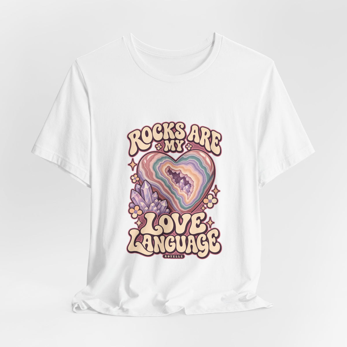 Royelle Rocks Are My Love Language T-shirt in White, hanging front view, with pastel agate heart, crystals and flowers and slogan.